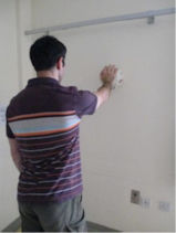 Single hand rolling ball on wall